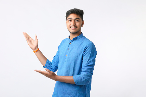 Indian man in tradition wear and giving expression on white background